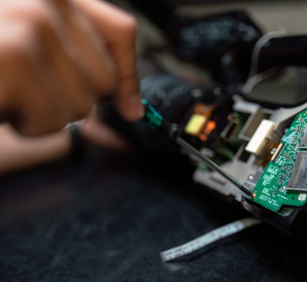 person holding green and black circuit board